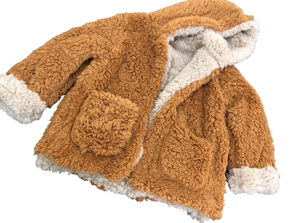 Tan hooded fleece jacket with cream trim and front patch pockets
