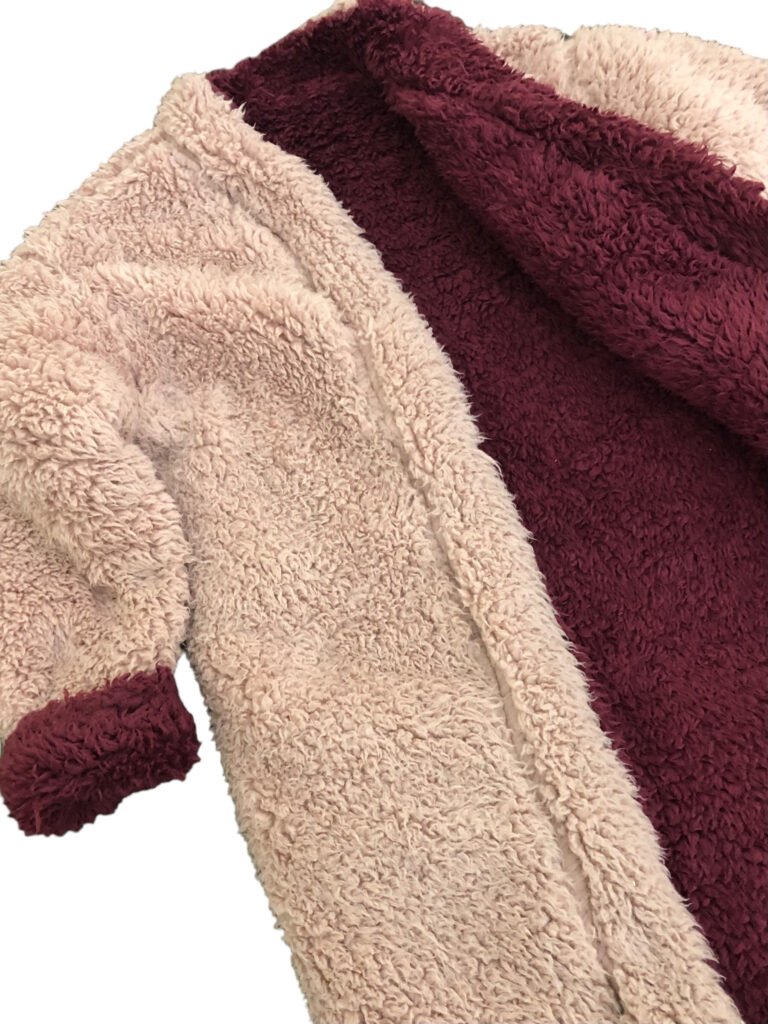 Close-up of cream and burgundy fleece fabric on a coat