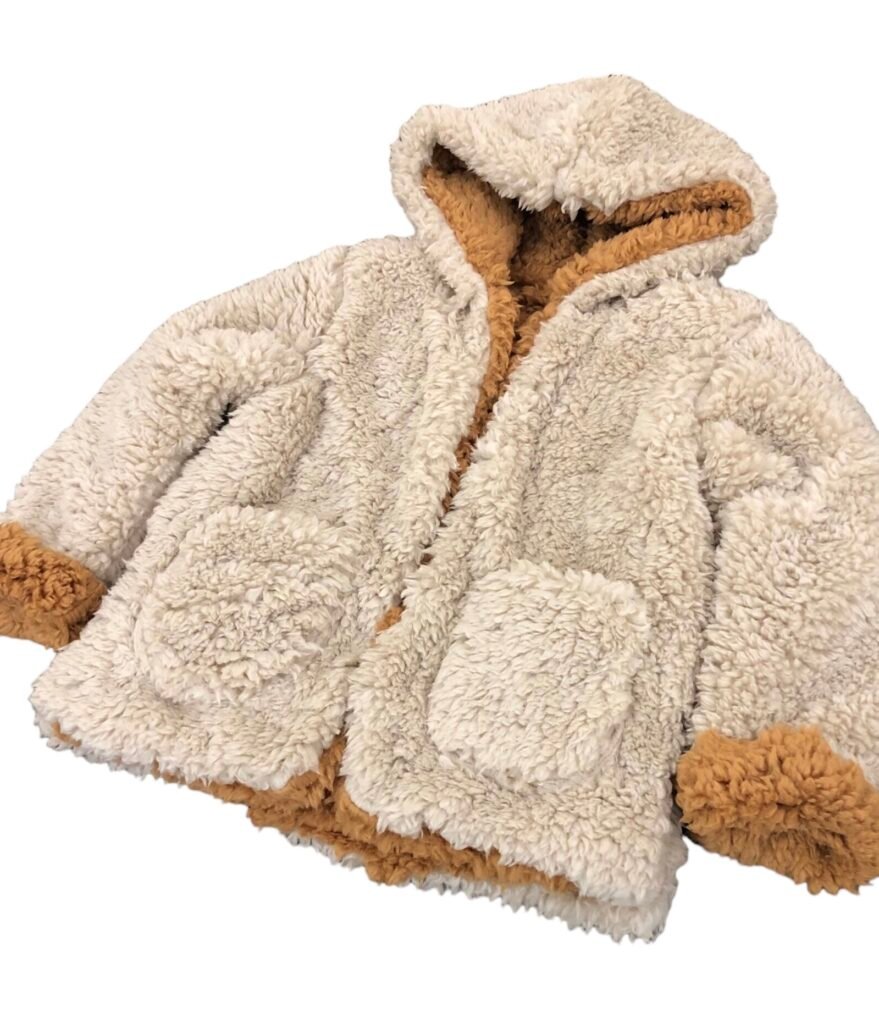 Cream textured fleece hooded jacket with a tan lining.