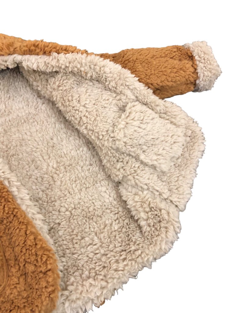 Close-up of a cream fleece jacket interior with tan sleeves