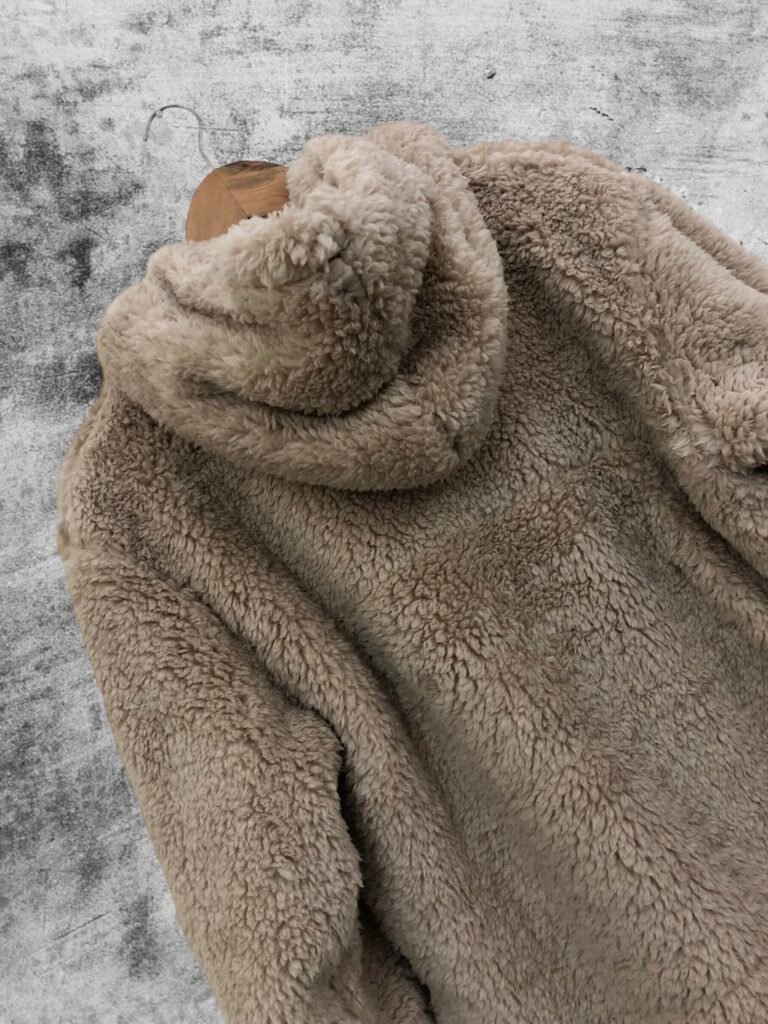 Back view of a taupe textured fleece hoodie on a hanger
