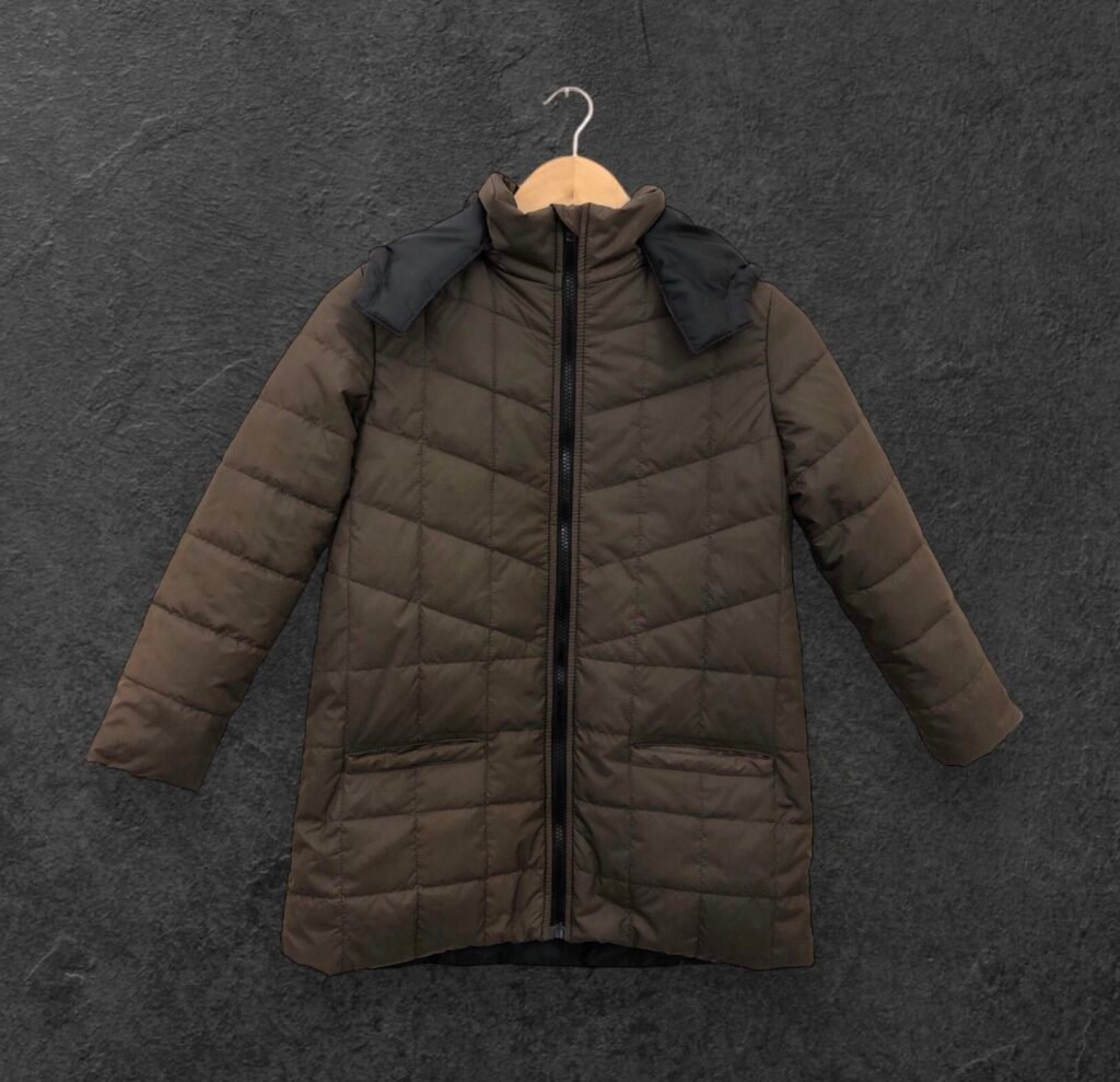Olive quilted puffer jacket with dark shoulder panels and a front zipper