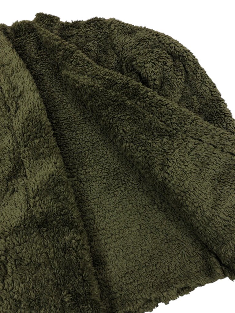 Close-up of the sleeve cuff on an olive green fleece jacket.