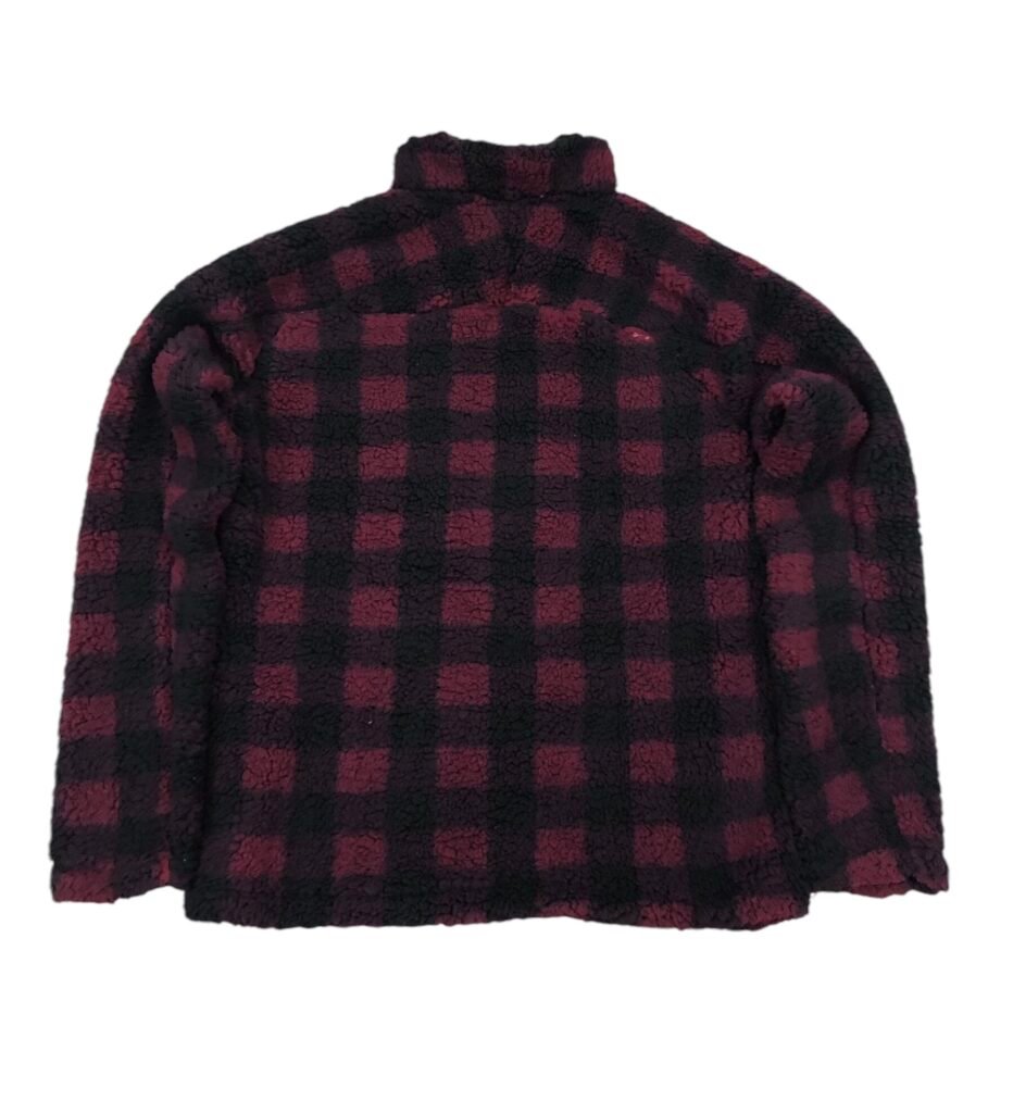 Back view of a red and black check fleece pullover.