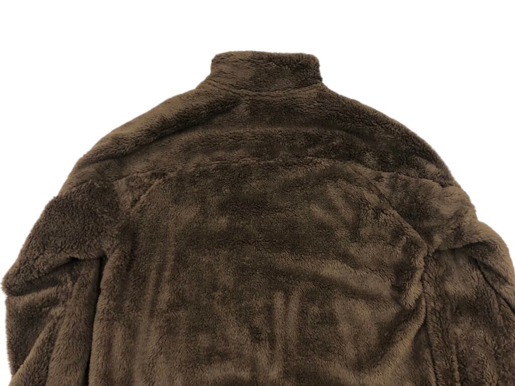 Close-up of the shoulder and collar on a brown fleece pullover.