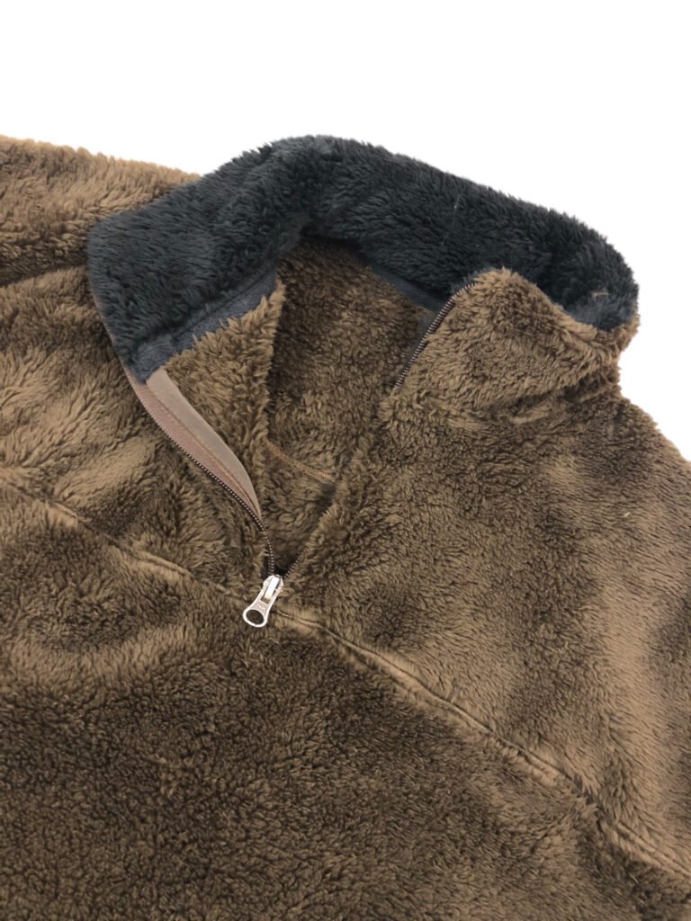 Close-up of the collar lining and zip on a brown fleece pullover.