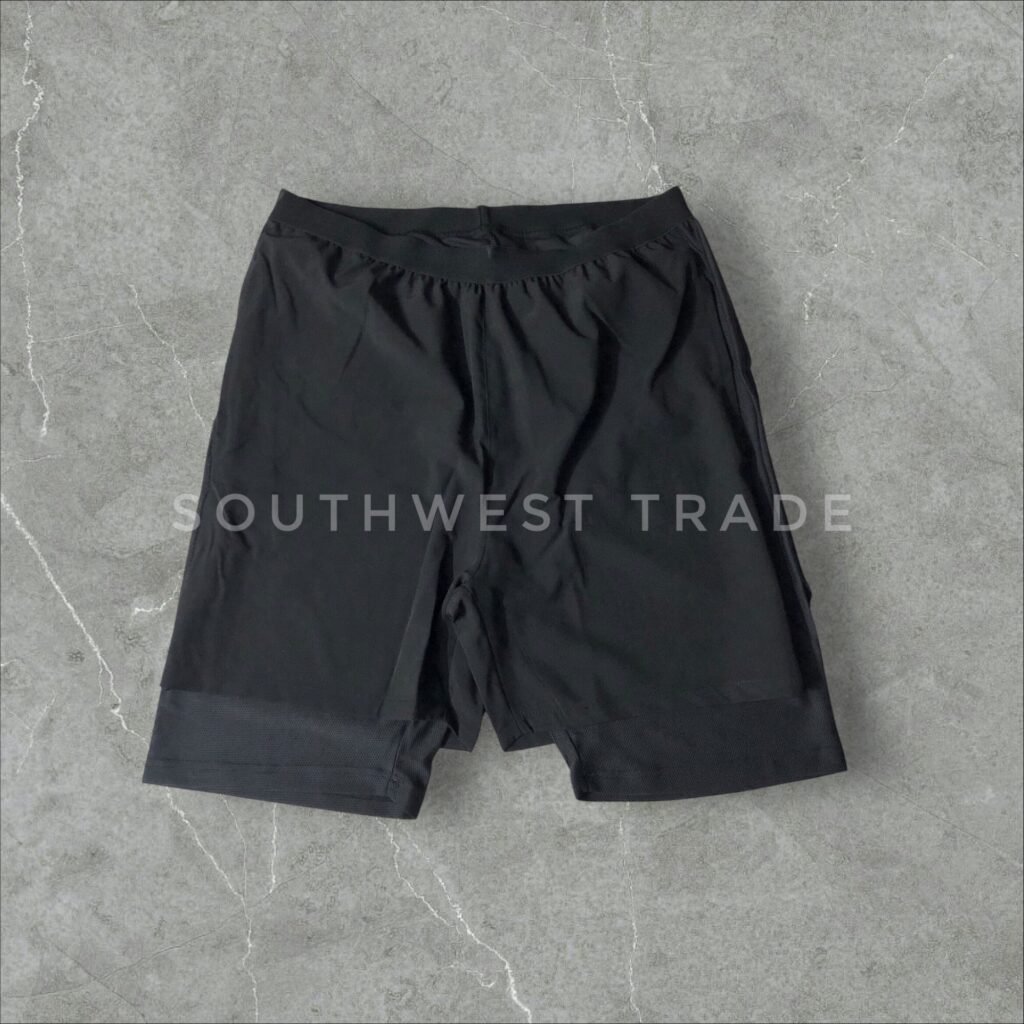 Black athletic shorts laid flat, front view.