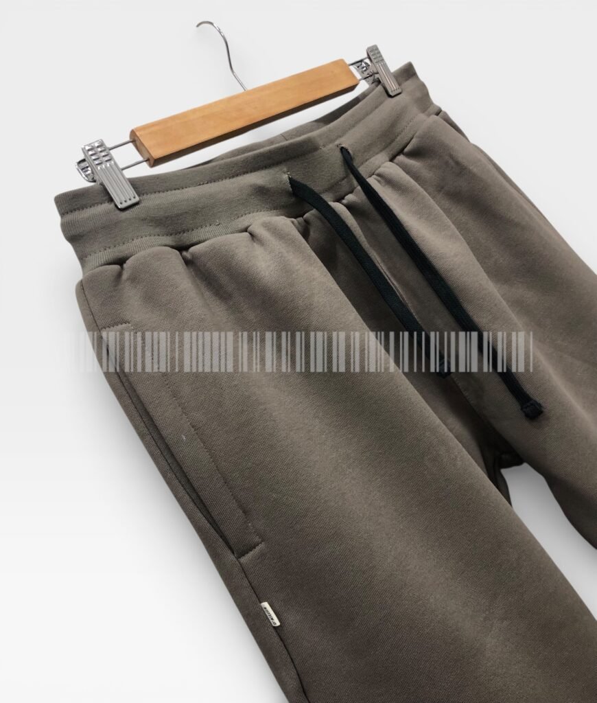 Close-up of the drawstring waistband on brown joggers.