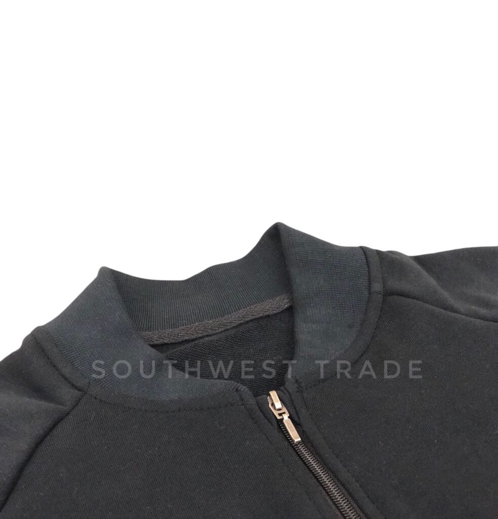 Close-up of the collar and zip on a dark grey pullover.