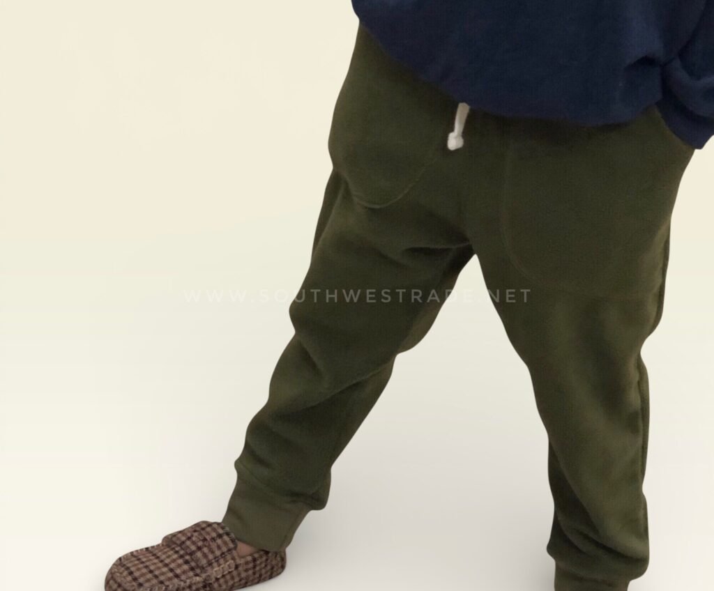 Olive green joggers shown from the side on a model.