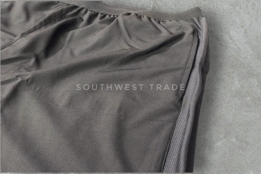 Close-up of a side pocket on black athletic shorts.
