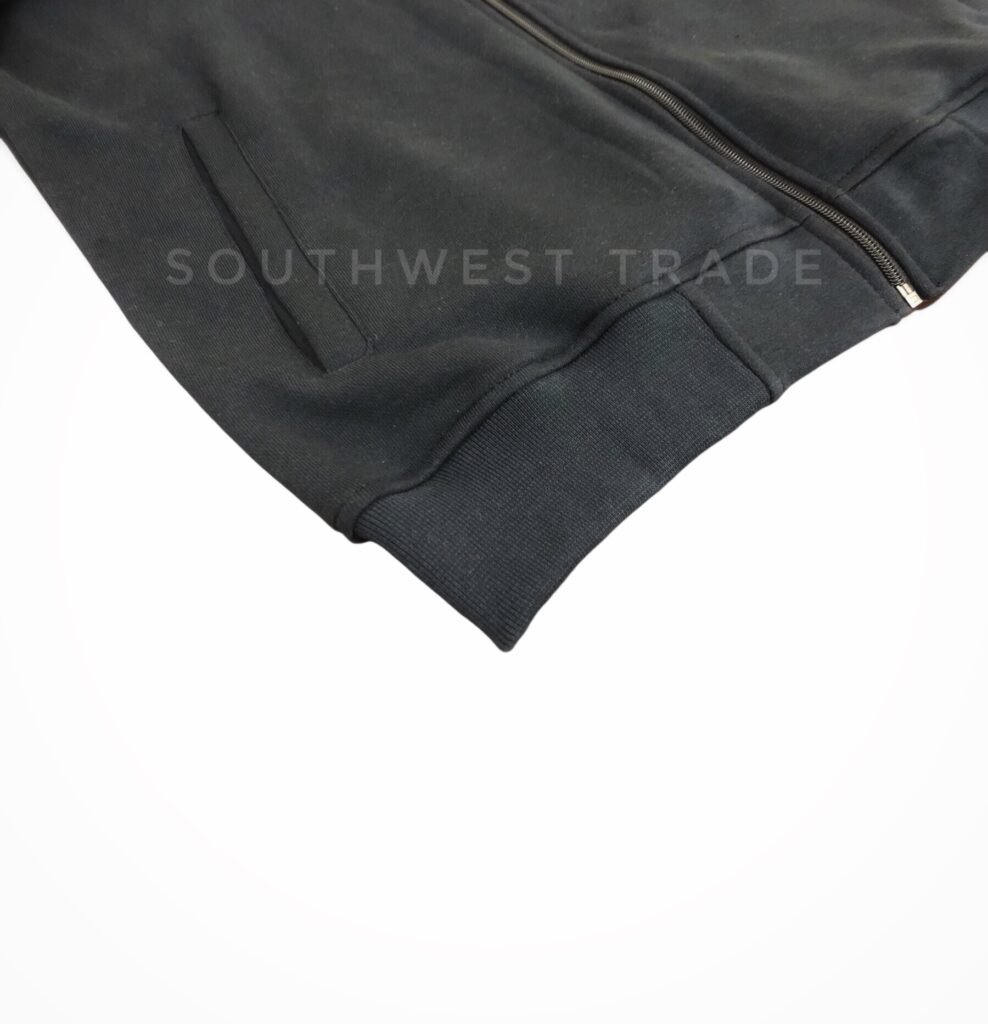 Close-up of the hem on a dark grey pullover.