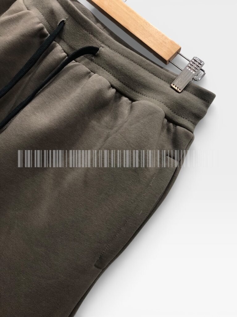 Close-up of the side seam on brown joggers.