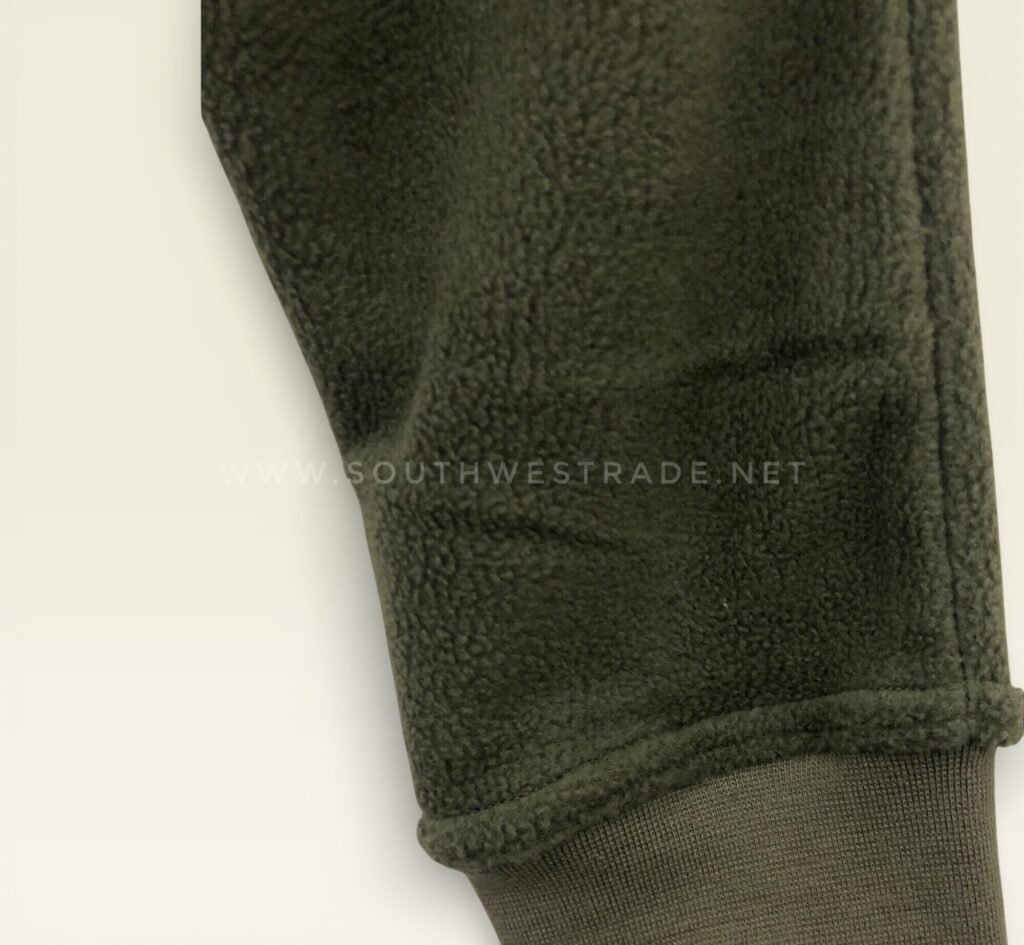 Close-up of the fabric on olive green joggers.