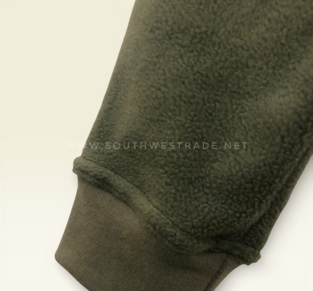 Close-up of the cuff on olive green joggers.