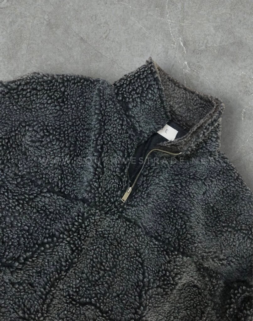 Close-up of the collar on a navy textured fleece pullover.