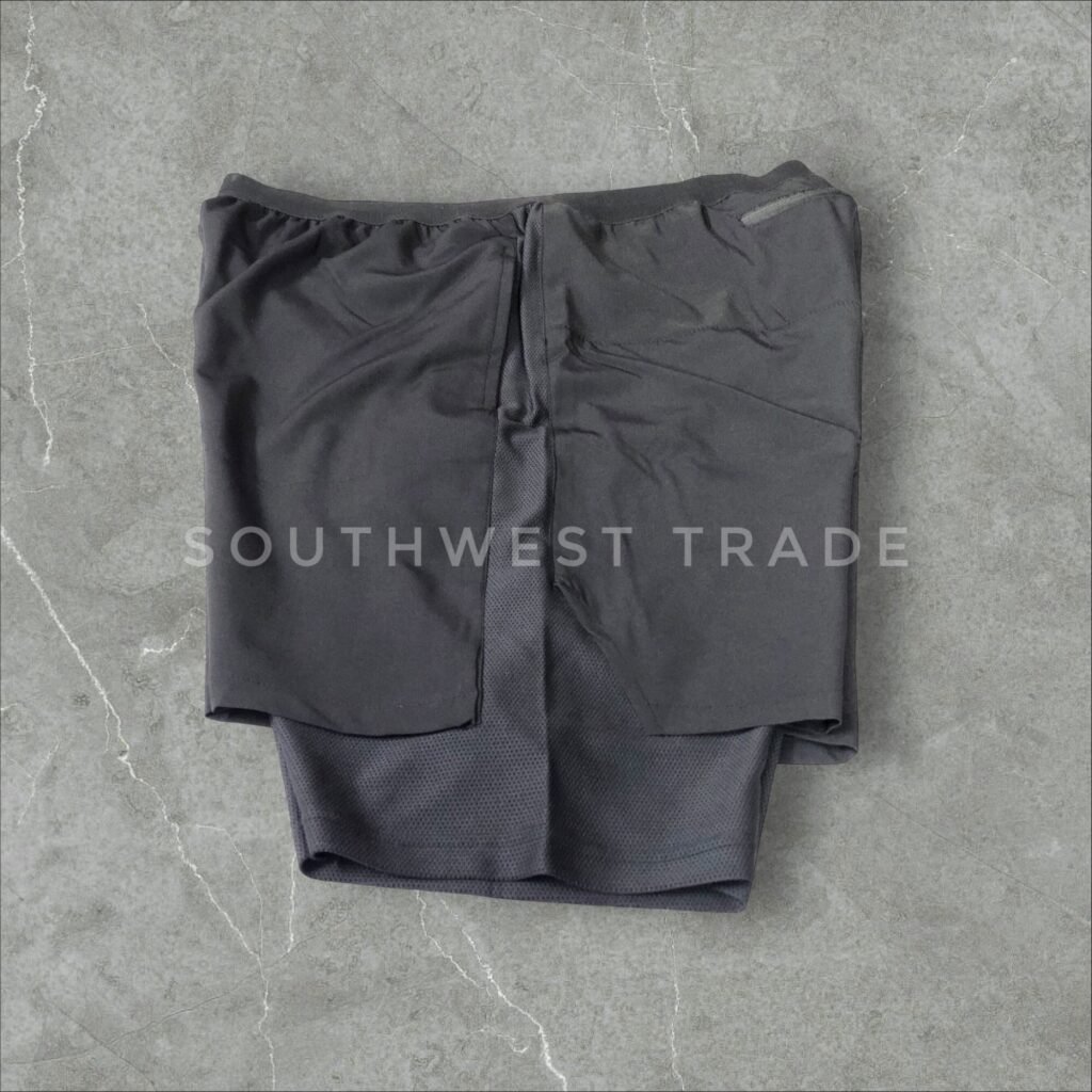 Black compression shorts with side pockets laid flat.