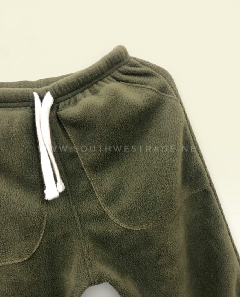 Close-up of the drawstring waistband on olive green joggers.