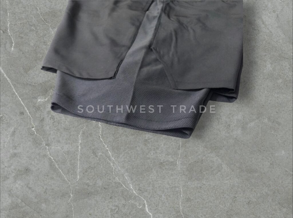 Close-up of a leg opening on black compression shorts.