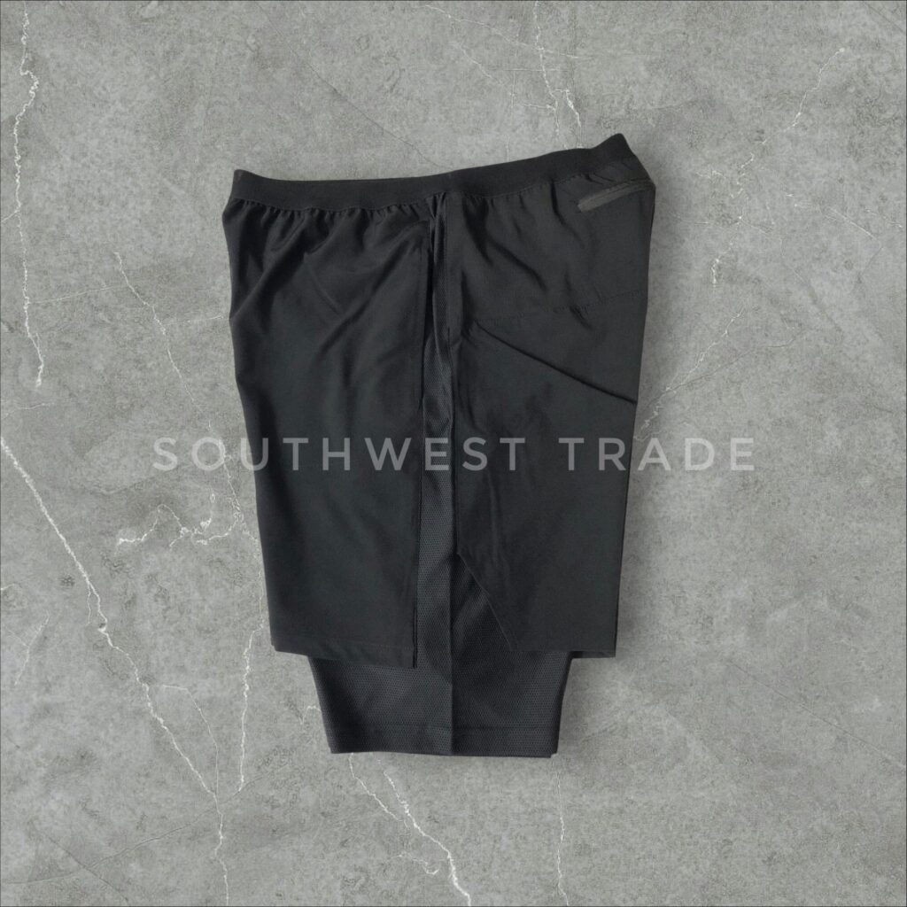 Black fitted athletic shorts laid flat.