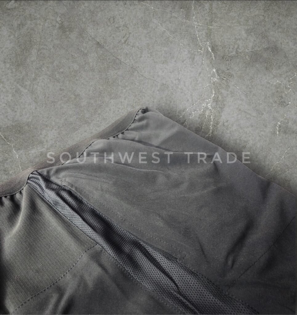 Close-up of the waistband and fabric on black athletic shorts.