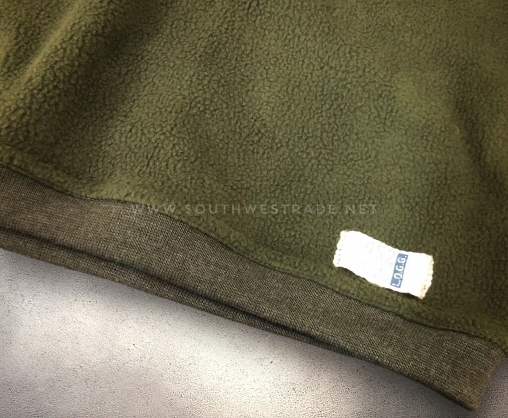 Close-up of the hem on an olive green sweatshirt.