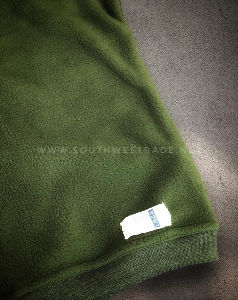 Close-up of the cuff on an olive green sweatshirt.