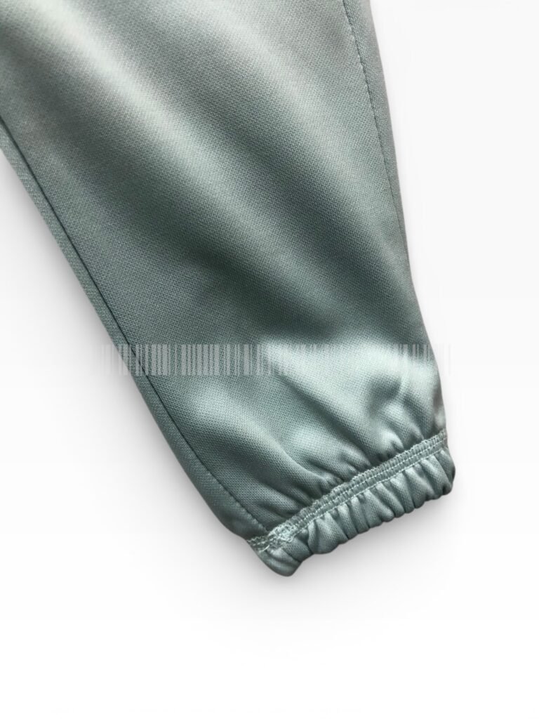 Close-up of the elastic ankle cuff on sage green joggers.