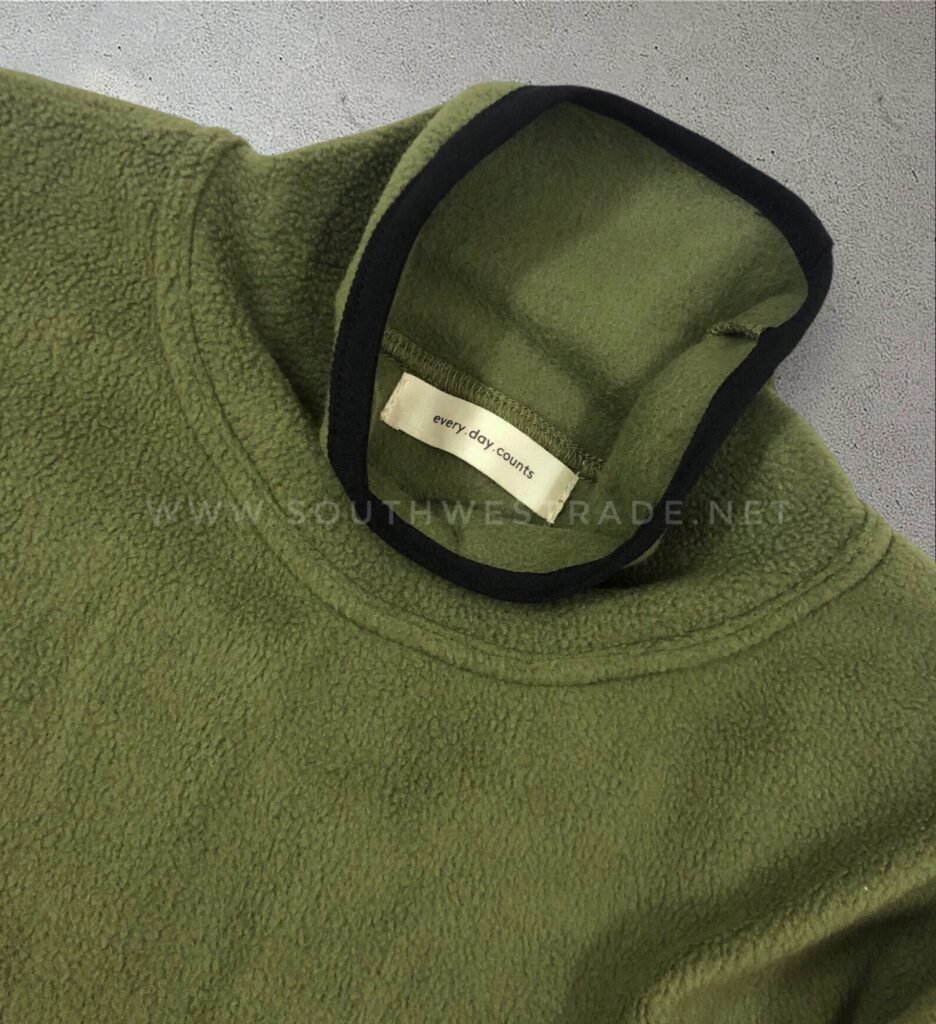 Close-up of the collar on an olive green sweatshirt.