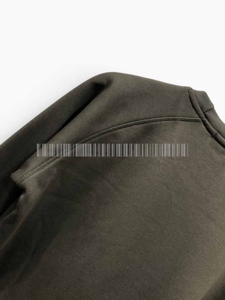 Close-up of the shoulder seam on a charcoal sweatshirt.