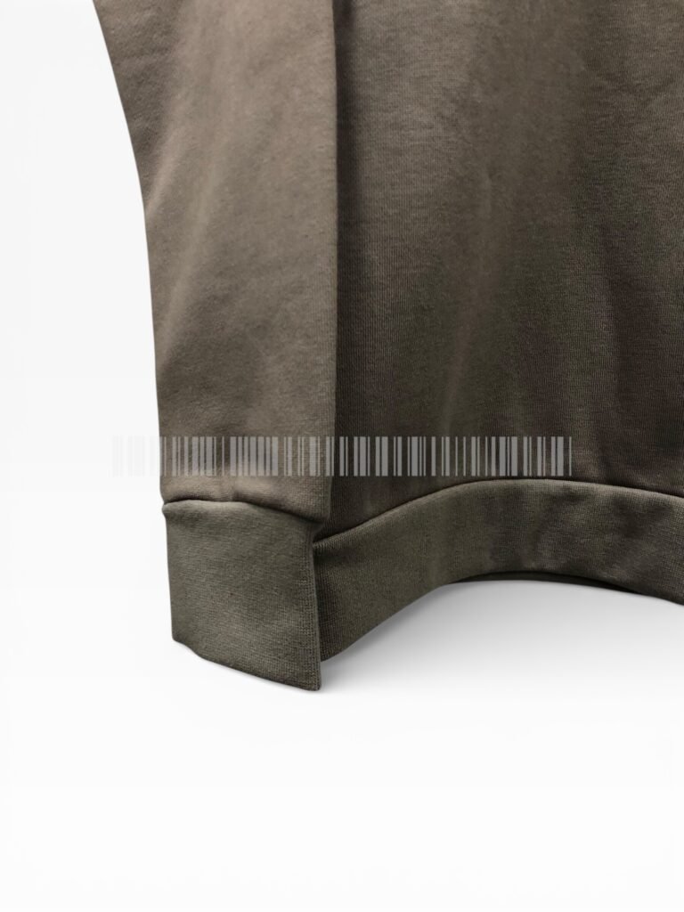 Close-up of the ribbed hem on a brown sweatshirt.