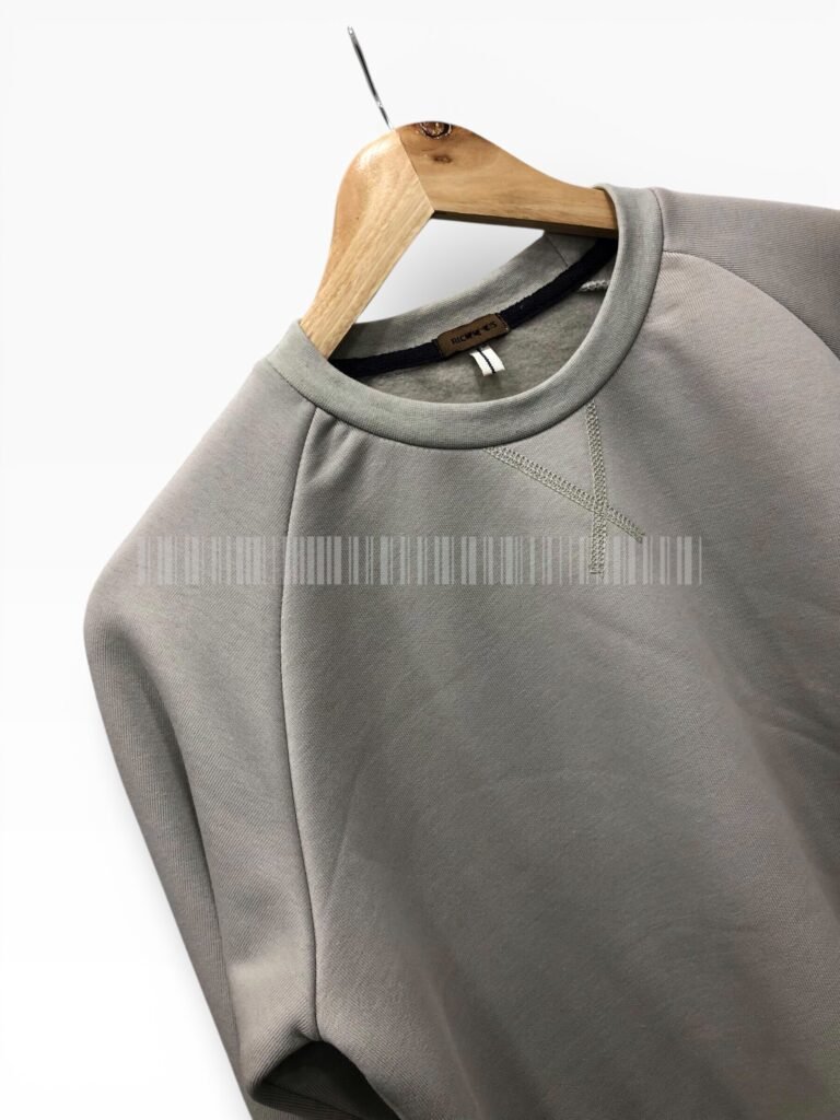Close-up of the collar on a light grey sweatshirt.