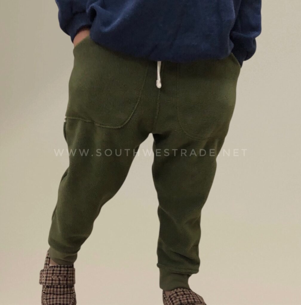 Olive green joggers worn by a model.