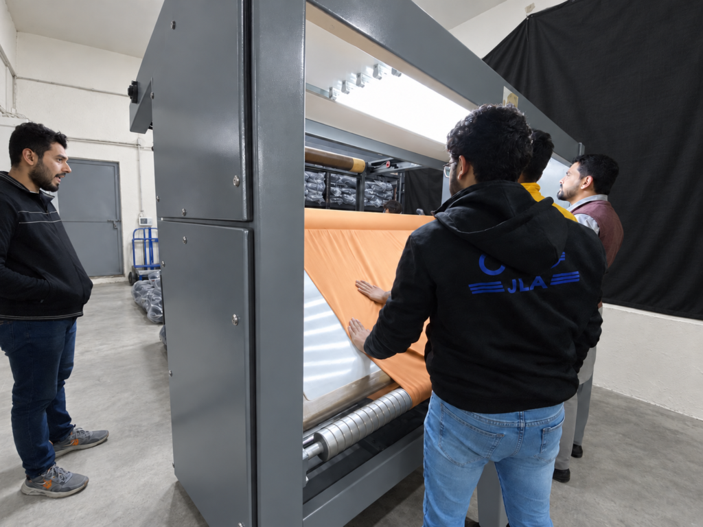 Workers inspecting orange fabric at our fabric supplier’s factory.